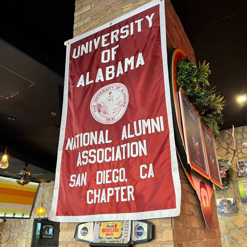 The San Diego chapter banner of the University of Alabama National Alumni Association hanging in the bar